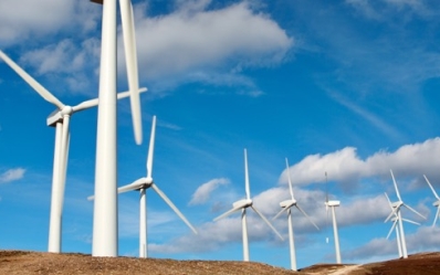 close up image of a wind turbine at sunset with clouds in the sky